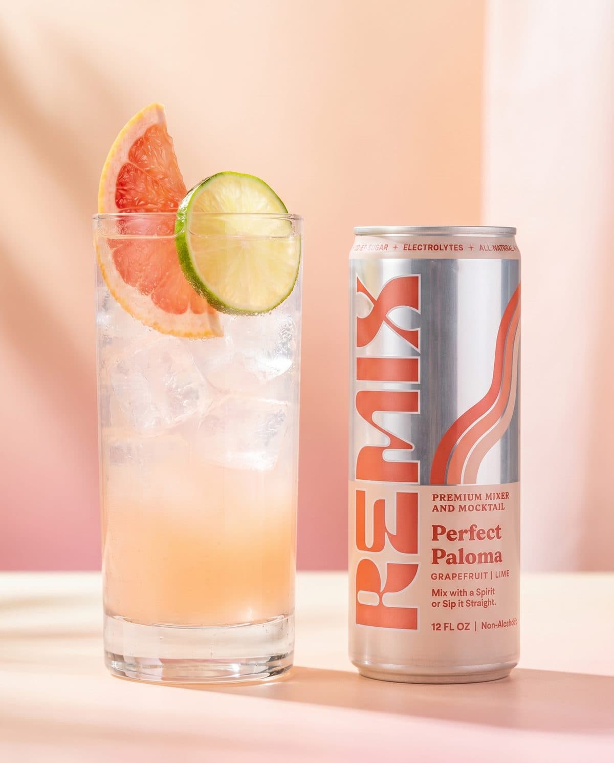 A Remix Perfect Paloma mocktail over ice with grapefruit and lime